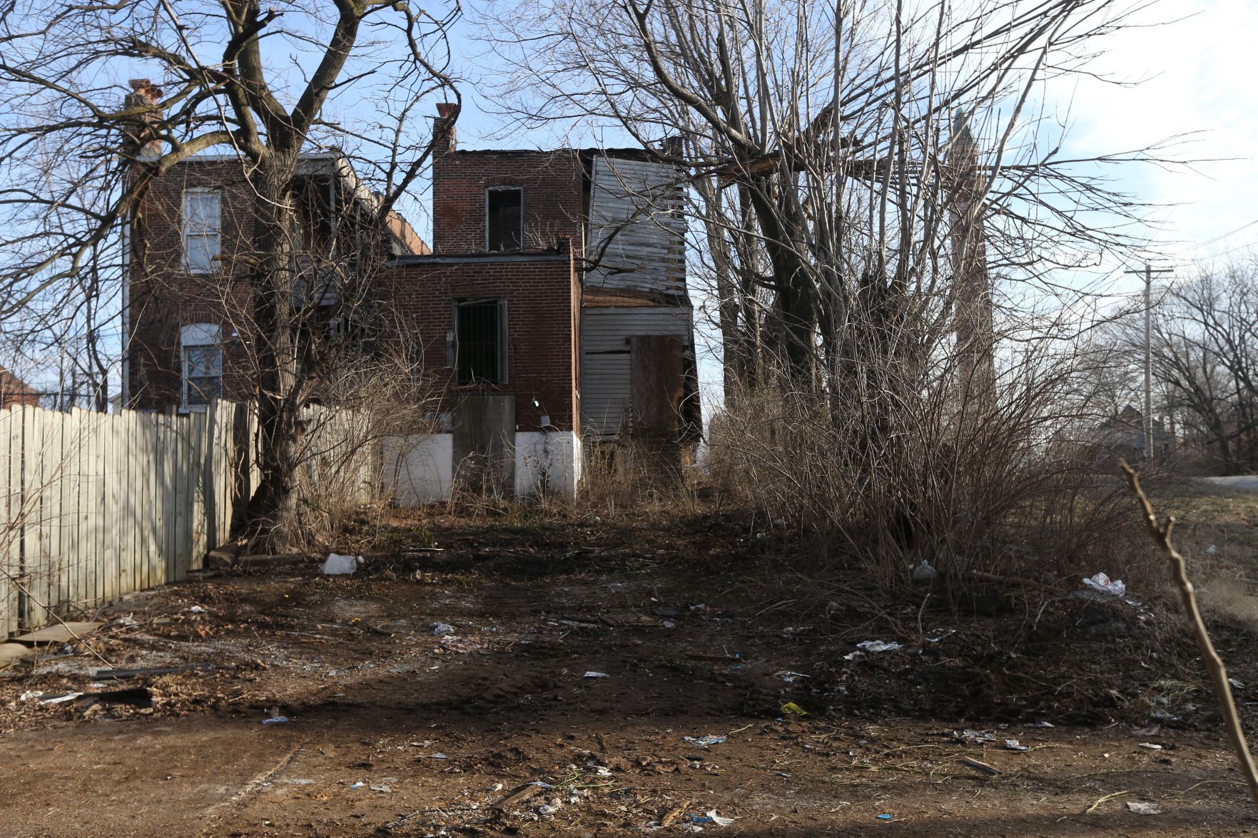 Trash and tires were piled up behind this home on 19th Street until city crews arrived